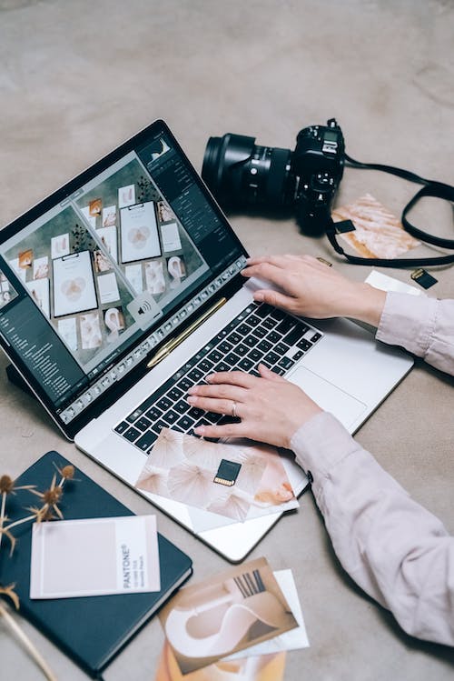 someone typing on a computer. Showing her making money as a photographer, and how to make money as a photographer 